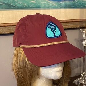 The baseball style cap. It includes a icon patch (the tree logo shown), a rope